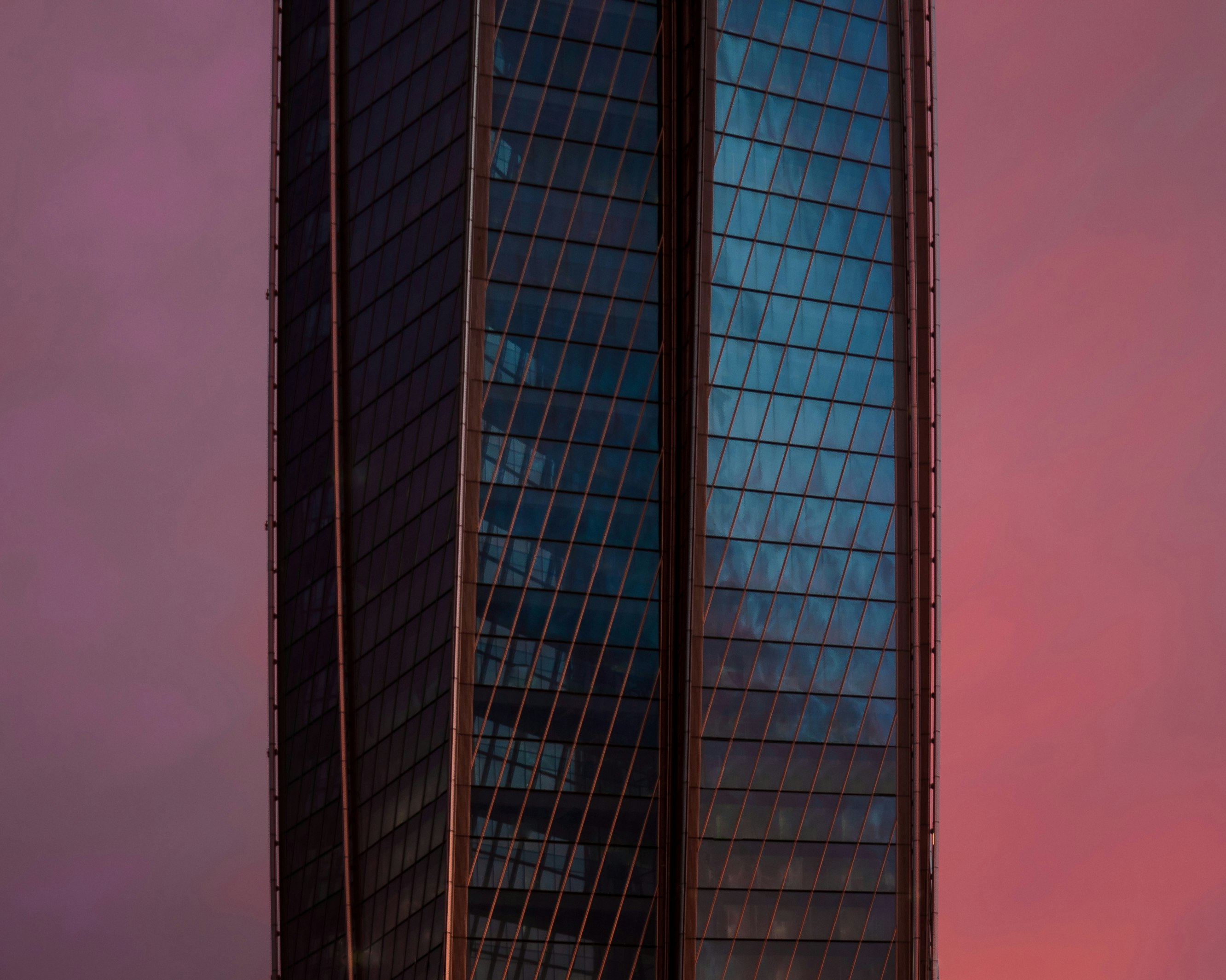 blue and white glass walled high rise building